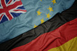 waving colorful flag of germany and national flag of Tuvalu.