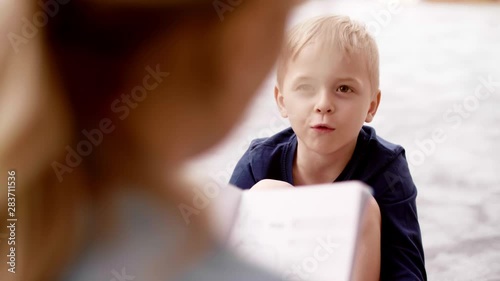 Little boy talking to teacher in the preschool Canvas Print