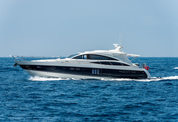 Wall Mural - White and blue luxury yacht in motion on the Mediterranean sea, side view, Liguria, Italy, Europe