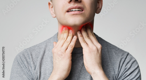 Cuadros en Lienzo Young man pulping his inflamed neck, close up