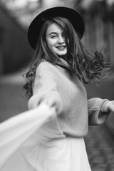 portrait of young redhead woman in wedding dress and sweater black and white