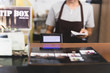 © bignai - Selected focus cashier register with female waitress operating in cafe.