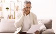 © Prostock-studio - Retired man talking on phone, discussing bills