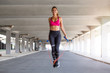 © Graphicroyalty - Fitness woman skipping with a jump rope outdoors. Female doing fitness training in morning. Athletic Beautiful Woman Exercises with Jump / Skipping Rope.