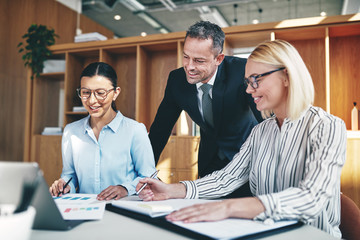 Smiling businesspeople working together at an office table