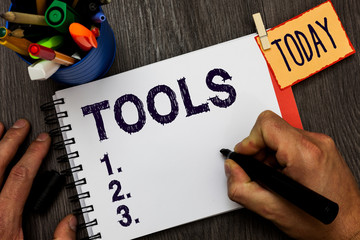 Poster - Handwriting text Tools. Concept meaning device implement like held and used carry out particular function Man holding marker notebook clothespin hold reminder cup markers wood table
