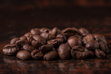 Coffee beans  on stone background. Top view with copy space for your text. Roasted coffee beans background. Beans texture, macro