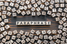 Paraphrase - Word From Wooden Blocks With Letters, Rewrite Retelling Using Other Paraphrase Words Concept, Random Letters Around, Top View On Wooden Background