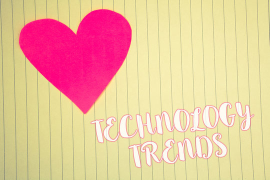 Word writing text Technology Trends. Business concept for Trending Modern Viral Advanced Development Trendy New Light pink heart symbol white paper backstage with outlines white letters
