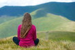 © Андрей Репетий - Young fitness woman practicing yoga at mountain peak while enjoying a beautiful landscape of mountains.
