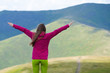 © Андрей Репетий - Girl hiker with a raised hands admiring a beuty of nature in the mountains.