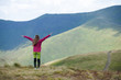 © Андрей Репетий - Rear view of a woman hiker admiring a beautiful landscape of mountains