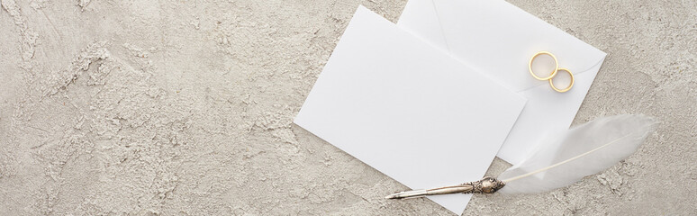 Wall Mural - panoramic shot of empty card and envelope near quill pen on textured surface