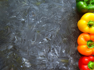 fresh organic ripe bell peppers or capsicum on grey table, top view. fresh vegetables bell red, yell