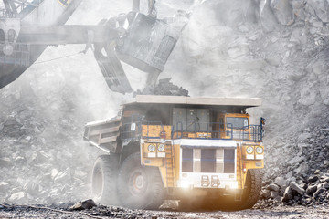 Wall Mural - Open mountain quarry. Loading coal into a mining truck.