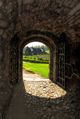 Wall Mural - Balvenie Castle entrance with stone floor and green field in the background, Dufftown, Scotland, UK