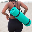 © Pixels in Colour - Rear view of woman carrying yoga mat