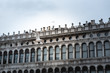 A building on St. Mark's Square in Venice with a seagull flying past him. With free space for inscription
