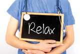 Fototapeta  - Doctor shows information on blackboard: relax.  Medical concept.