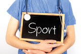 Fototapeta  - Doctor shows information on blackboard: sport.  Medical concept.