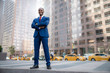 © elnariz - Powerful stance portrait of a successful and accomplished African American CEO businessman, in financial district with city skyscrapers in background