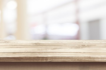 Canvas Print - Brown desk in a white empty room lit by the sun