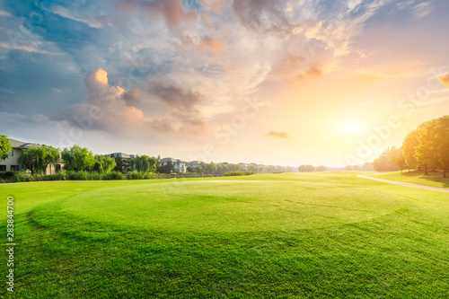 green-grass-and-beautiful-sunset-clouds-in-the-city-park