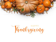 Thanksgiving Greetings. Pumpkins And Dry Leaves On A White Background. Top View.