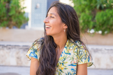 Young indian woman laughing in the street