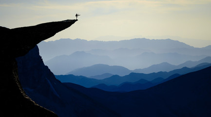 silhouette of strong man defying nature