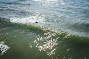 Wall Mural - Aerial view on surfer in the sea, surfer catching waves in baltic sea.