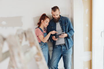 Young couple discussing data on a tablet together