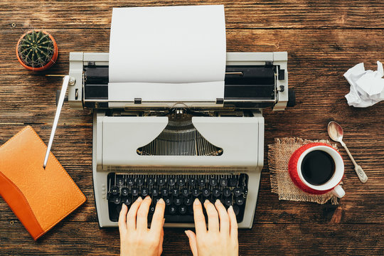 Typewriter with woman hands