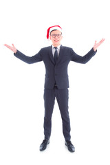 Wall Mural - Full length of handsome asian businessman wearing suit and santa claus hat standing and smiling isolated over white background