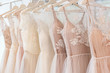wedding dresses hanging on racks