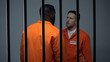 Afro-american and caucasian criminals quarreling in prison racial discrimination