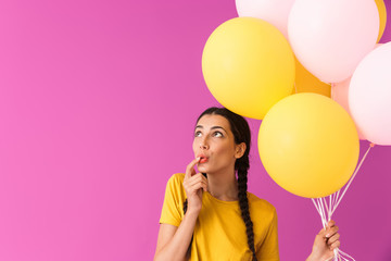 Sticker - Image of cute young woman looking upward at copyspace while holding air balloons