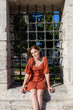 © Solidasrock - Beautiful girl with orange colored dress posing with Suleymaniye Mosque's Fence