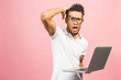 © denis_vermenko - Young african american businessman using computer laptop annoyed and frustrated shouting with anger, crazy and yelling with raised hand, anger concept.