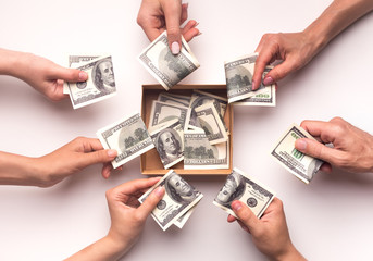 People together collecting money in box for funding them