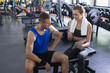 © wavebreak3 - Female trainer and man interacting with each other while using digital tablet in fitness center