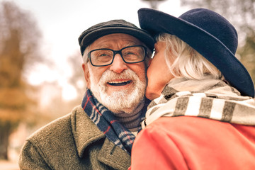 Close up of a happy smiling couple kissing in park