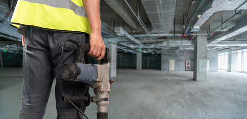 Construction Worker in front of construction site