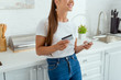 © LIGHTFIELD STUDIOS - cropped view of cheerful woman holding smartphone and credit card