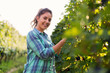 Portrait of young woman working in vineyard
