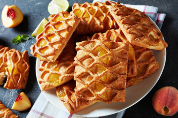 Wall Mural - puff pastry pies on a white plate, close-up