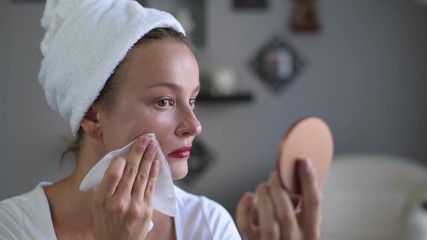 Wall Mural - Beautiful woman removing makeup from her face, skin care