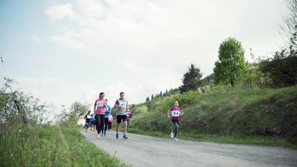 Sticker - Large group of multi generation people running a race competition in nature.