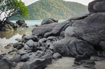 rocky mountain on a sandy beach with moutain view at hat mai ngam island at chumphon in thailand