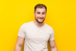 © luismolinero - Handsome man over yellow background having doubts and with confuse face expression